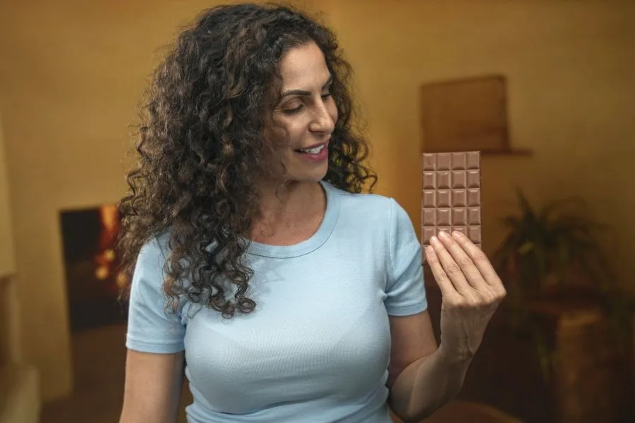 woman holding a chocolate bar